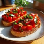 Two slices of toasted bread topped with a vibrant mixture of diced tomatoes and fresh basil, showcasing a perfect bruschetta recipe.