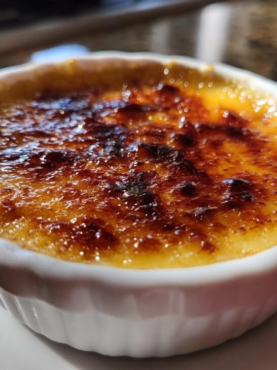 Close-up of a Decadent Creme Brulee Recipe with a perfectly caramelized sugar crust.