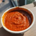 A close-up of a bowl filled with vibrant, textured All Purpose Al Pastor Marinade.