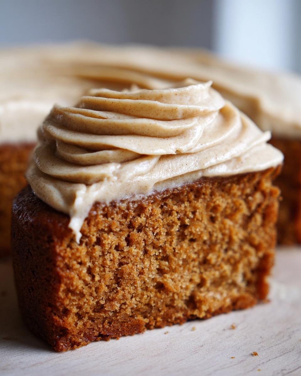 A slice of moist Apple Cider Cake topped with swirls of rich Cinnamon Maple Buttercream.