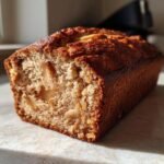 Close-up of a slice of Apple Cinnamon Olive Oil Cake, showing tender crumb and visible apple pieces.