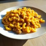 A close-up of a serving of My Childhood Homemade Hamburger Helper with elbow macaroni and ground beef in a creamy cheese sauce.