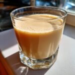 Close-up of a glass filled with creamy, light brown Jamaican Rum Cream Alcohol Free beverage.