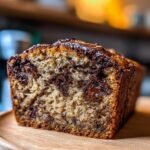 Close-up of a slice of Irresistible Chocolate Chip Banana Bread, showcasing moist crumb and melted chocolate chips.