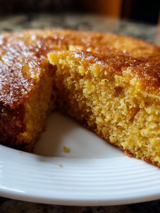 A slice of moist One Layer Maple Sweet Potato Cake on a white plate, showcasing its tender crumb.
