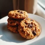 A stack of four delicious Peanut Butter Oatmeal Chocolate Chip Cookies resting on a white plate.