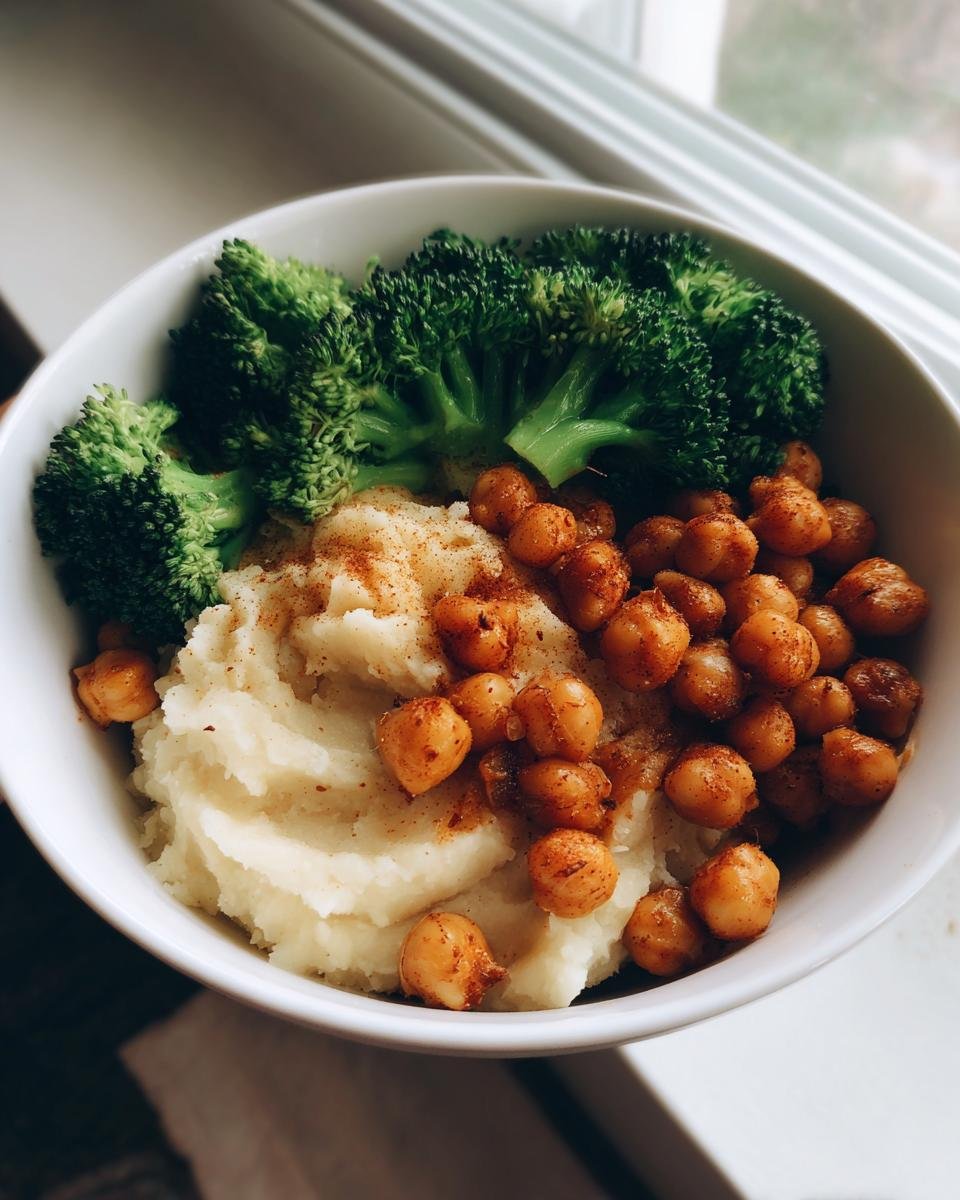 Close-up of a Vegan Chickpea Broccoli Mashed Potato Buddha Bowl with roasted chickpeas and steamed broccoli.