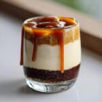 Layered Caramel Macchiato Chia Pudding with rich caramel sauce dripping down the sides of the glass.