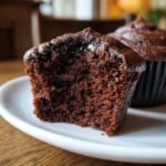 Close-up of a Vegan Chocolate Gingerbread Cupcakes half, showing the rich, moist, dark crumb texture.