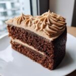 A perfect slice of dark Vegan Gingerbread Cake topped with piped brown Vegan Gingerbread Cake Chai Buttercream.