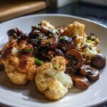 Close-up of perfectly roasted cauliflower florets and saut&eacute;ed mushrooms in the Garlic Cauliflower Mushroom Skillet.