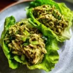 Close-up of two fresh Pesto Chicken Lettuce Wraps filled with shredded chicken and green pesto mixture.