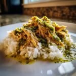 Close-up of shredded Tender Salsa Verde Chicken and Rice served on a white plate.