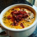 Close-up of a rich, creamy Jalapeno Popper Soup Bacon topped generously with crispy bacon bits and parsley.